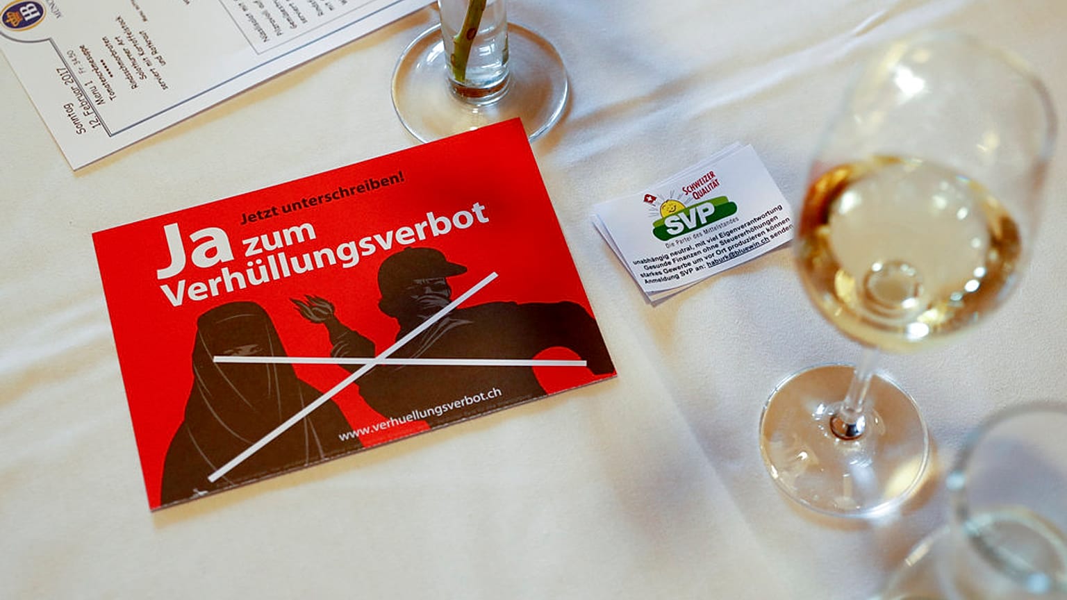 In this Feb. 12, 2017 file photo a leaflet reading "Yes to the ban on veiling'' is on display at the reunion of the Swiss People's Party SVP in Dornach, Switzerland