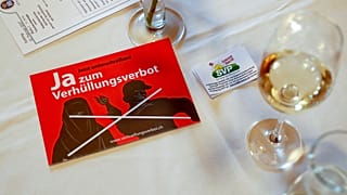 In this Feb. 12, 2017 file photo a leaflet reading "Yes to the ban on veiling'' is on display at the reunion of the Swiss People's Party SVP in Dornach, Switzerland