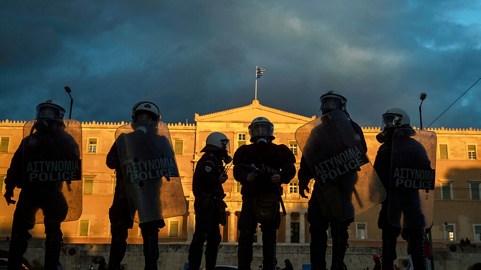 Riot police stand guard in front of the Greek parliament in central Athens
