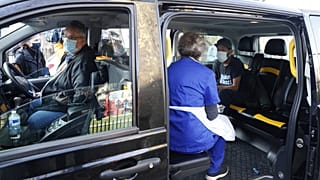 Dr Tamara Joffe prepares to give a Covid-19 jab to Leslie Reid in the back of a London Taxi cab during the pilot project of pop up vaccination drive 'Vaxi Taxi'.