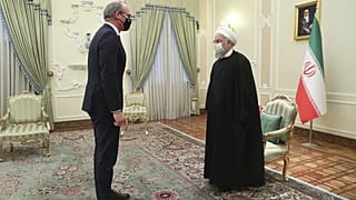 Iranian President Hassan Rouhani, right, and Irish Foreign Minister Simon Coveney greet at the start of their meeting in Tehran, Iran, Sunday, March 7, 2021.