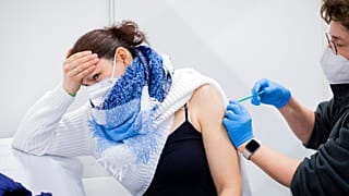 AstraZeneca's vaccine is administered by a doctor in Koelnmesse, Cologne.