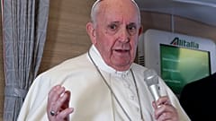 Pope Francis speaks to journalists, Monday, March 8, 2021, while flying back to The Vatican at the end of his four-day trip to Iraq.
