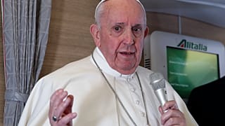 Pope Francis speaks to journalists, Monday, March 8, 2021, while flying back to The Vatican at the end of his four-day trip to Iraq.