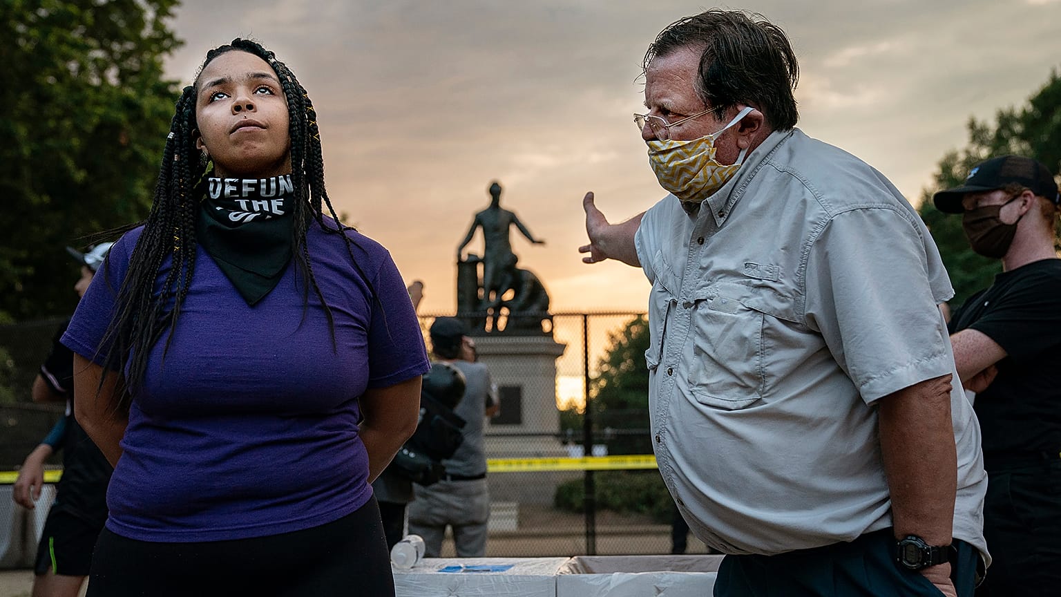 Anais (26) argues for the removal of the Emancipation Memorial with a man (right) who wishes to keep it, in Lincoln Park, Washington DC, USA. June 25, 2021