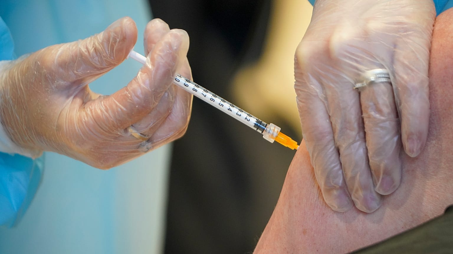 A health worker administers a dose of the AstraZeneca vaccine against COVID-19 to a patient in Rome, Italy on March 10, 2021.