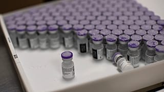 FILE - In this Monday, Jan. 4, 2021 file photo, frozen vials of the Pfizer/BioNTech COVID-19 vaccine are taken out to thaw, at the MontLegia CHC hospital in Liege, Belgium. 