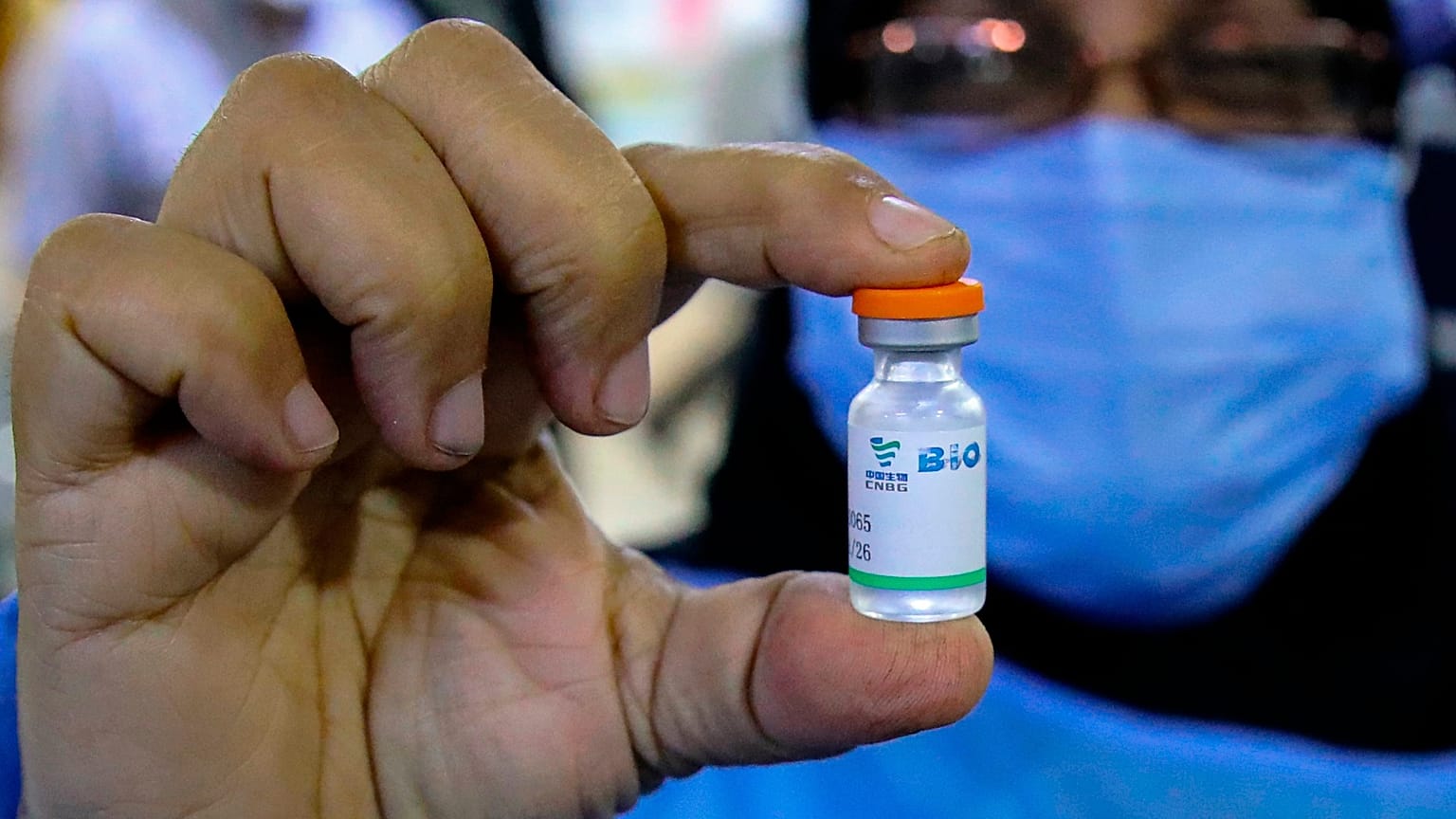 A health worker holds a vial of the Sinopharm coronavirus vaccine during the vaccination of health personnel, at a clinic in Basra, Iraq, March 3, 2021. 