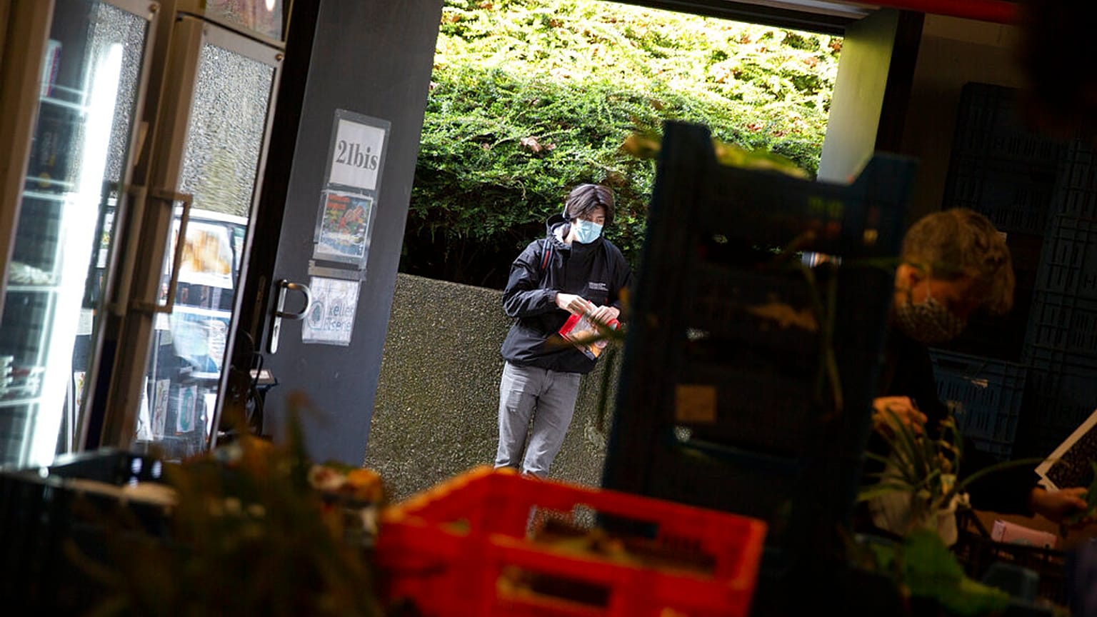 Students from the Free University of Brussels wait in a line to pick up products at the Frigo Partage food bank in Brussels on Monday, March 8, 2021