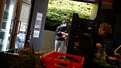 Students from the Free University of Brussels wait in a line to pick up products at the Frigo Partage food bank in Brussels on Monday, March 8, 2021