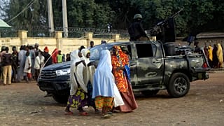 Parents are reunited with their daughters in Jangabe, Nigeria, Wednesday, March 3, 2021. 