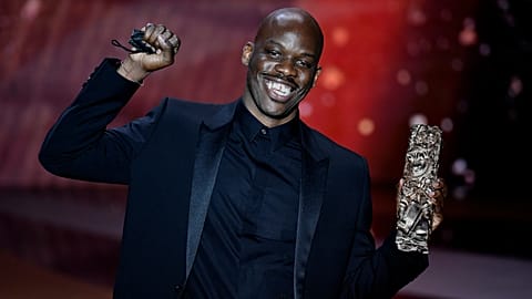 French actor Jean-Pascal Zadi poses with his trophy after receiving the Best Male Newcomer award for "Simply Black" during the 46th Cesar Award ceremony, March 12, 2021.