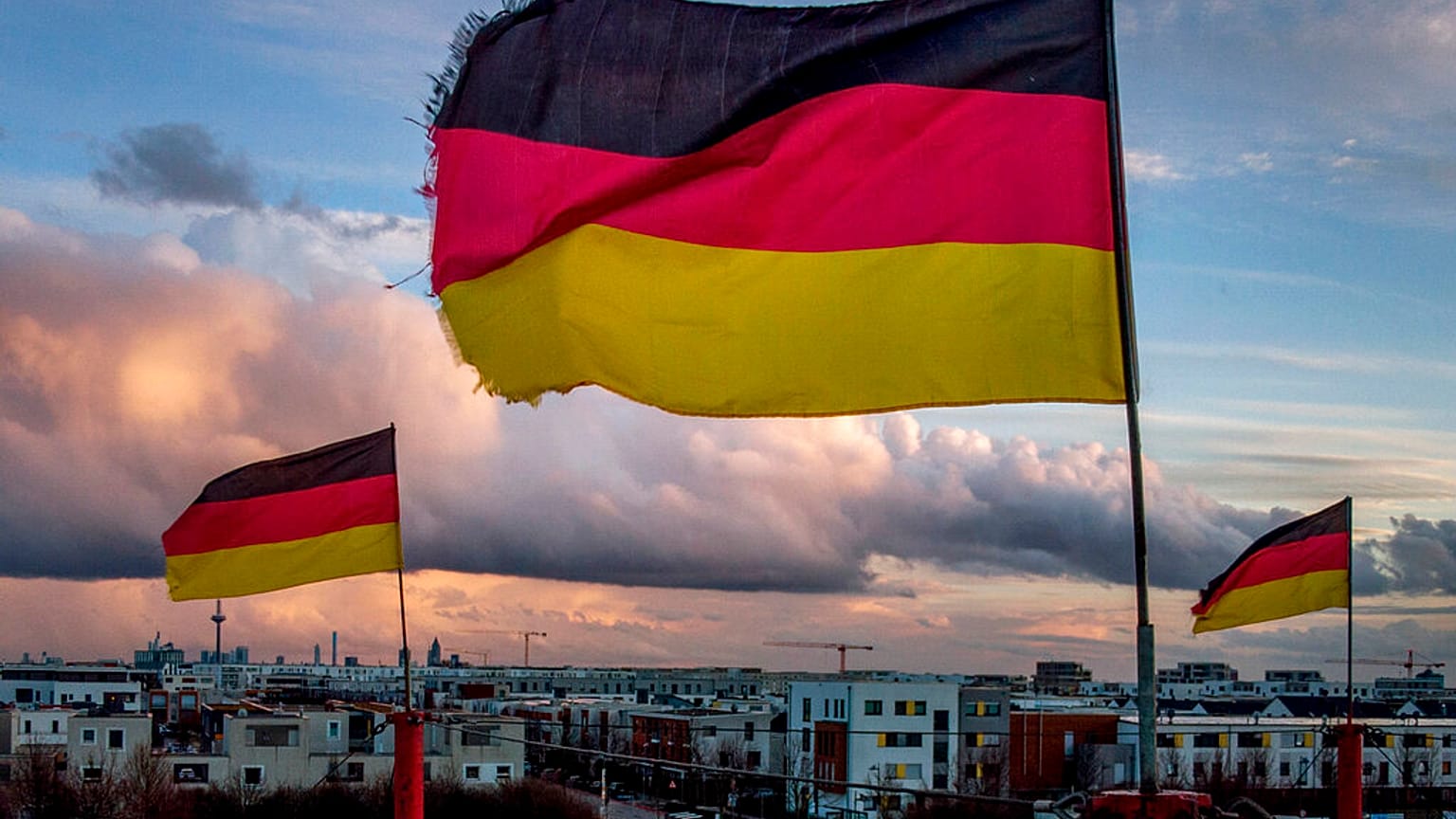 German flags wave in the wind on poles of a small circus in Frankfurt, Germany, March 13, 2021. 