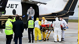 A patient infected with COVID-19 is loaded into a plane heading to a western France hospital, at Orly airport, south of Paris, Sunday, March 14, 2021.