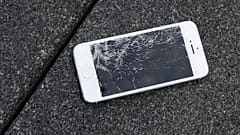 A broken Apple iPhone in need of repairs.