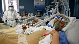 Husband and wife Giuseppe and Rosina hold hands in the Covid Intensive Care of the San Filippo Neri hospital in Rome, March 16, 2021. 