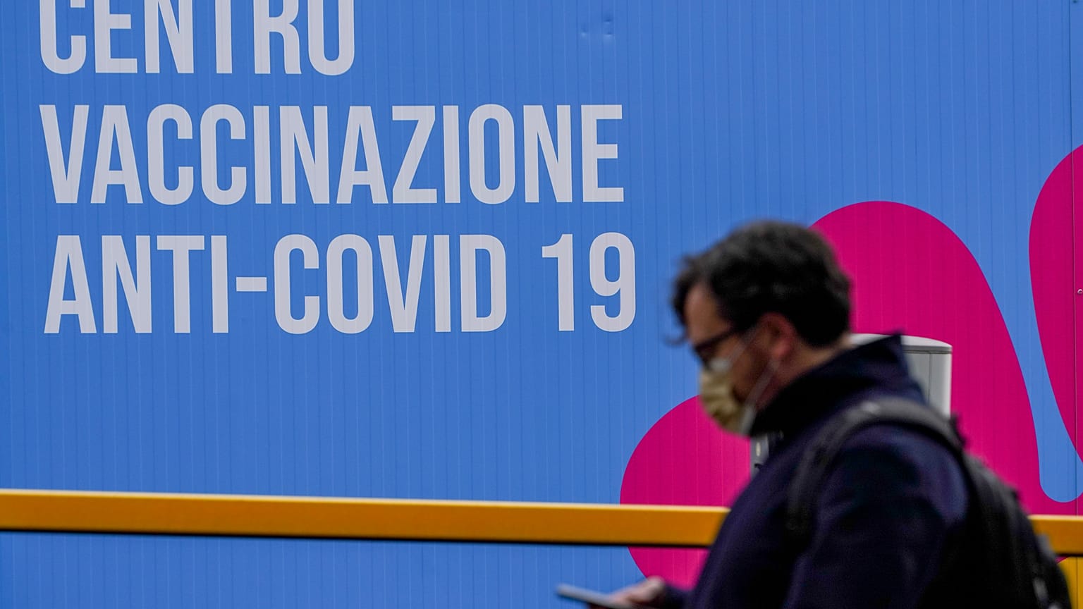A person walks past a closed vaccination center, in Rome, Tuesday, March 16, 2021