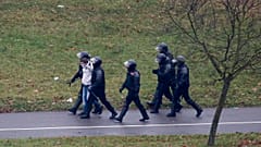 Belarusian riot police detain a demonstrator during an opposition rally in Minsk in November.