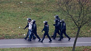Belarusian riot police detain a demonstrator during an opposition rally in Minsk in November.