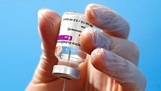 A health worker prepares a dose of the AstraZeneca vaccine to be administered at a vaccination center set up in Fiumicino, near Rome's international airport