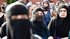 People oppose a burqa ban in Denmark. A similar ban exists in Austria, under which an animal rights activist was fined for wearing a cow mask. 