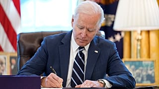 President Joe Biden signs the American Rescue Plan, a coronavirus relief package, in the Oval Office of the White House, Thursday, March 11, 2021, in Washington.