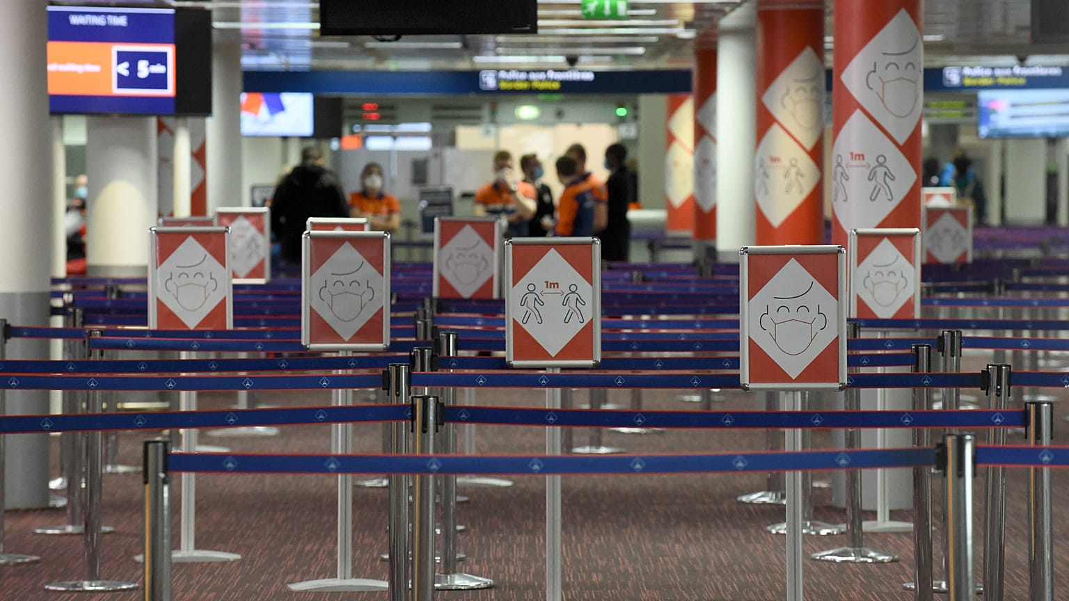Placards with pictograms depicting Covid-19 sanitary instructions are pictured in Terminal 2E at the Roissy-Charles de Gaulle airport near Paris, March 18, 2021.