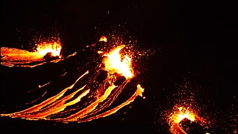 In this still image captured from a video filmed by the Icelandic Coast Guard, lava flows from the erupting Fagradalsfjall volcano, March 19, 2021.