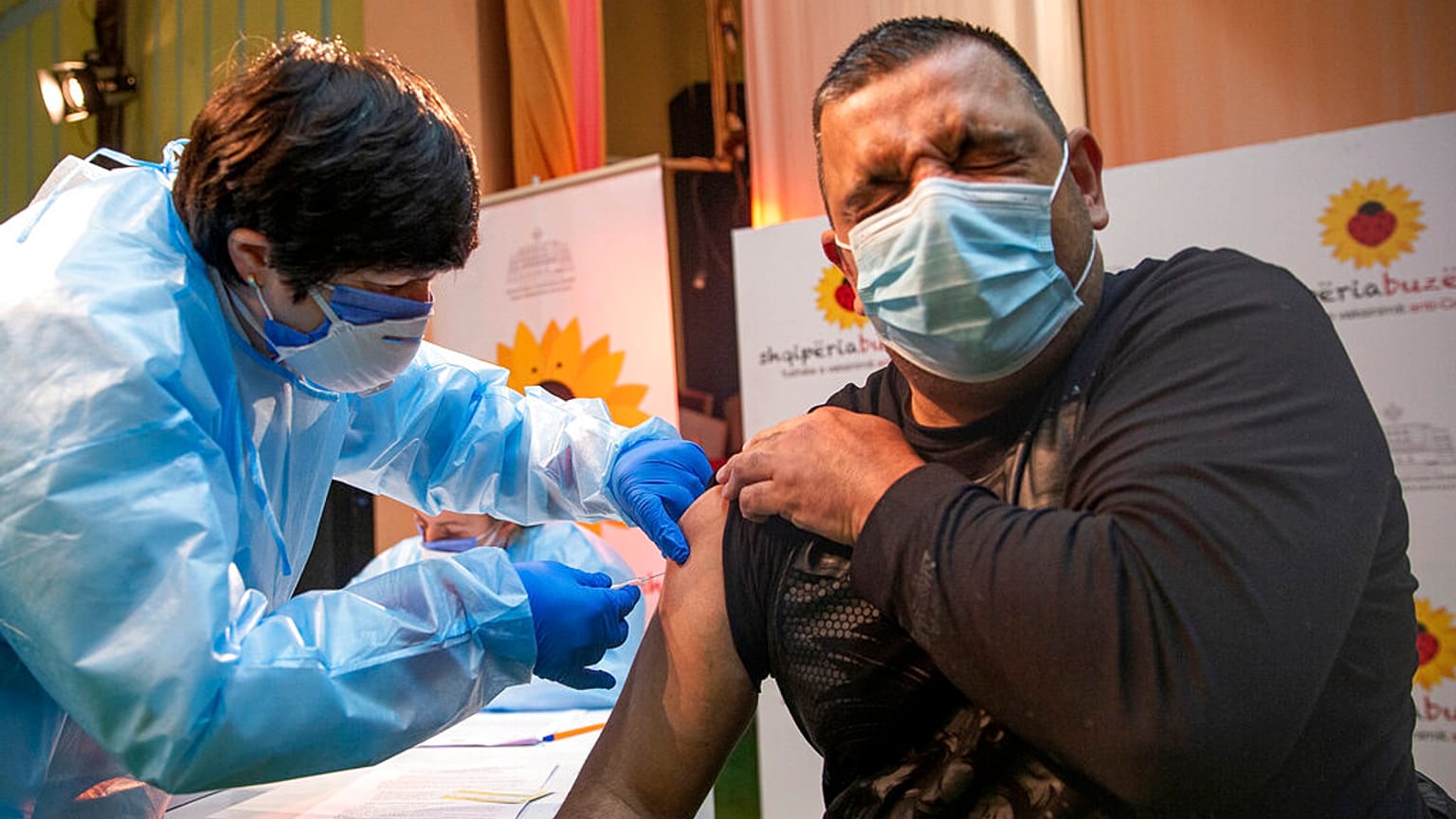 An Albanian nurse administers a AstraZeneca coronavirus vaccine to a Kosovo doctor in the northern Albanian town of Kukes on Saturday, March 20, 2021.