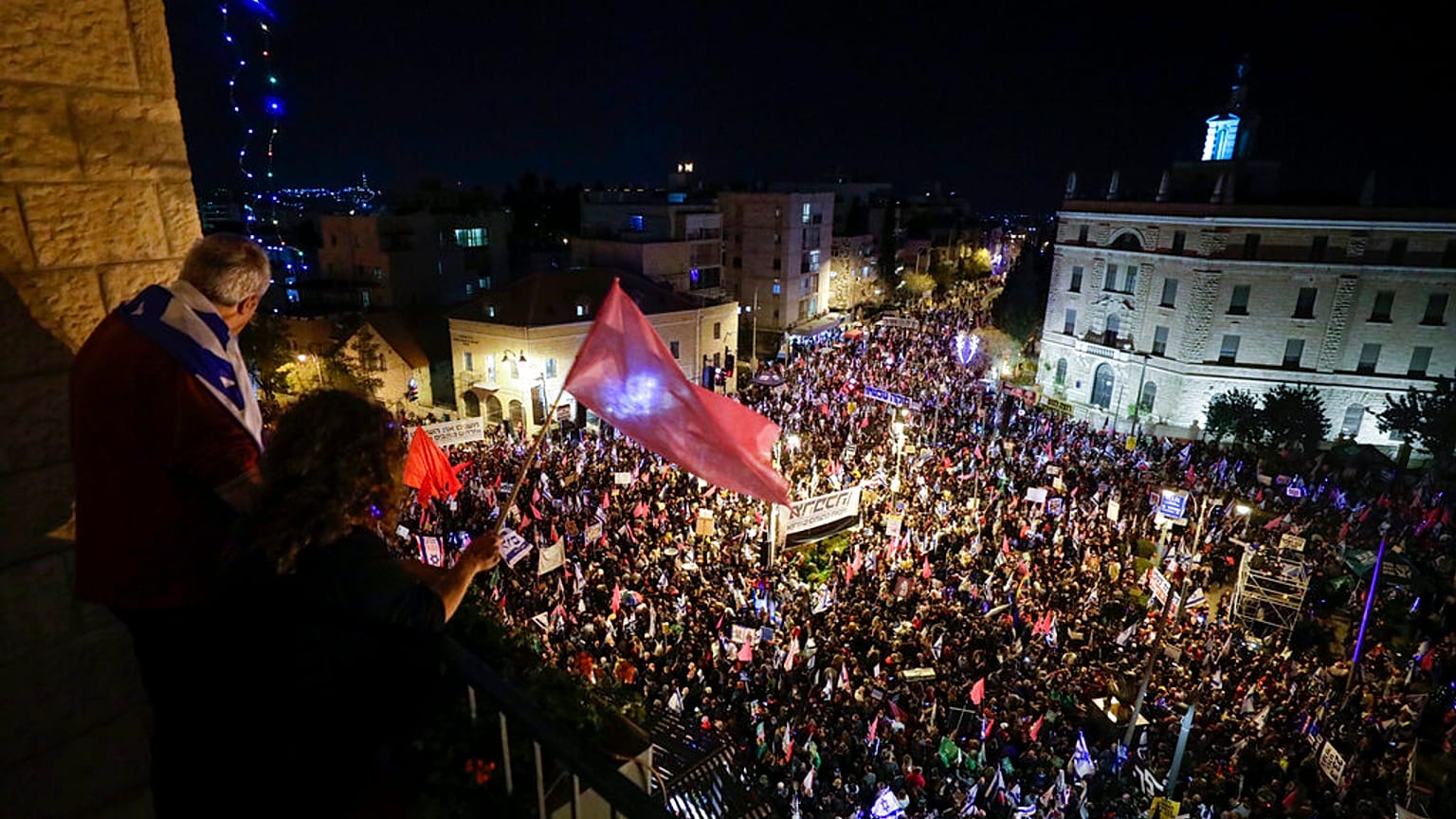 Thousands of protesters chant slogans and hold signs during a protest against Israel's Prime Minister Benjamin Netanyahu outside his residence in Jerusalem, Saturday, March. 2