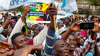 Supporters of opposition presidential candidate Guy Brice Parfait Kolelas cheer during their party's last rally of the presidential campaign in Brazzaville, Congo.