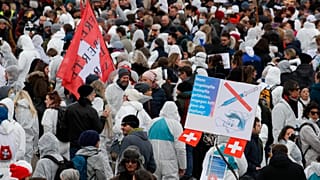 Protesters take part in a demonstration against the ongoing coronavirus Covid-19 restrictions in Liestal, near Basel, Switzerland, on March 20, 2021. 