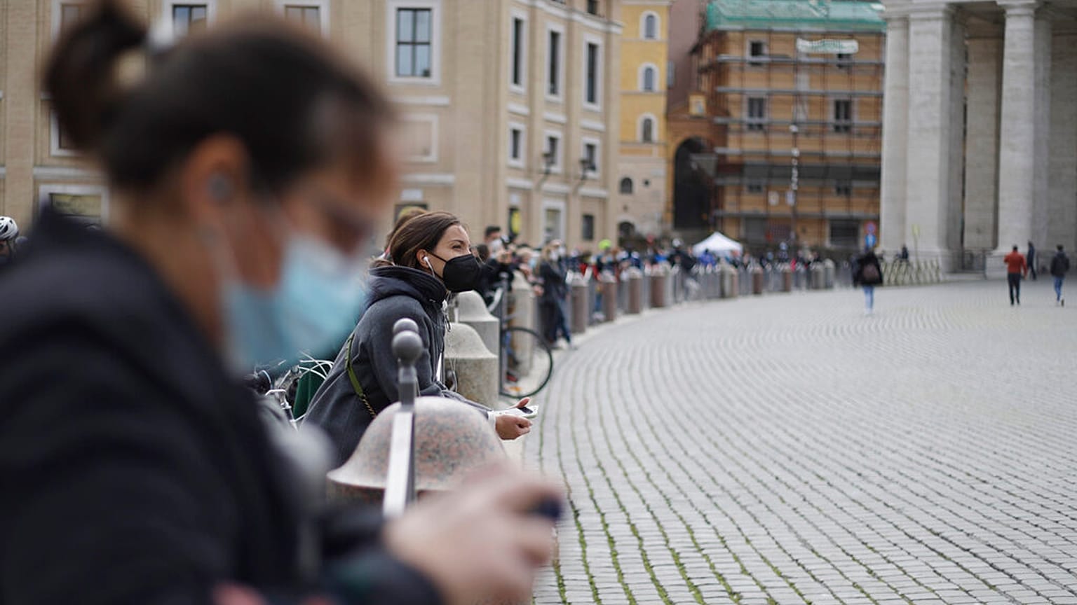People gather outside St. Peter's Square during Pope Francis Angelus prayer, at the Vatican, Sunday, March 21, 2021.