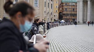 People gather outside St. Peter's Square during Pope Francis Angelus prayer, at the Vatican, Sunday, March 21, 2021.