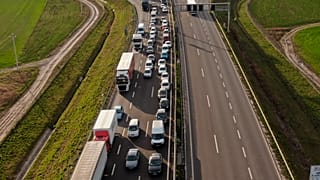 Vehicles wait in long lines to cross into Romania from Hungary at the Csanadpalota border crossing, after Hungary closed its borders to all but its own citizens in March 2020