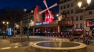 Empty streets in front of the Moulin Rouge as the 7 p.m curfew starts in Paris, France, on Saturday, March 20, 2021. 