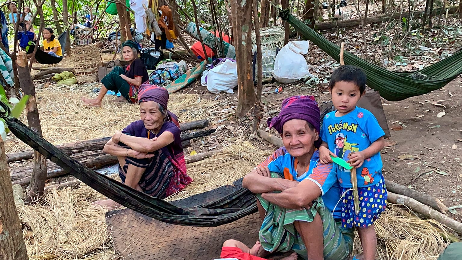 In this photo released by the Free Burma Rangers, Karen women sit with family members in the jungles of northern Karen State, Myanmar.  