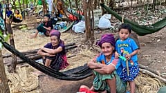 In this photo released by the Free Burma Rangers, Karen women sit with family members in the jungles of northern Karen State, Myanmar.  
