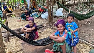 In this photo released by the Free Burma Rangers, Karen women sit with family members in the jungles of northern Karen State, Myanmar.  