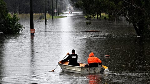 Residents commute via boat in a flooded residential area near Windsor, New South Wales. 