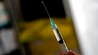 A medical staff prepares Pfizer's COVID-19 vaccine at a vaccination site in Boulogne Billancourt, outside Paris, Friday, March 19, 2021