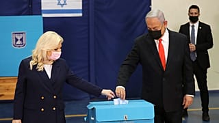 Israeli Prime Minister Benjamin Netanyahu and his wife Sara cast their ballots at a polling station as Israelis vote in a general election, in Jerusalem. March 23, 2021