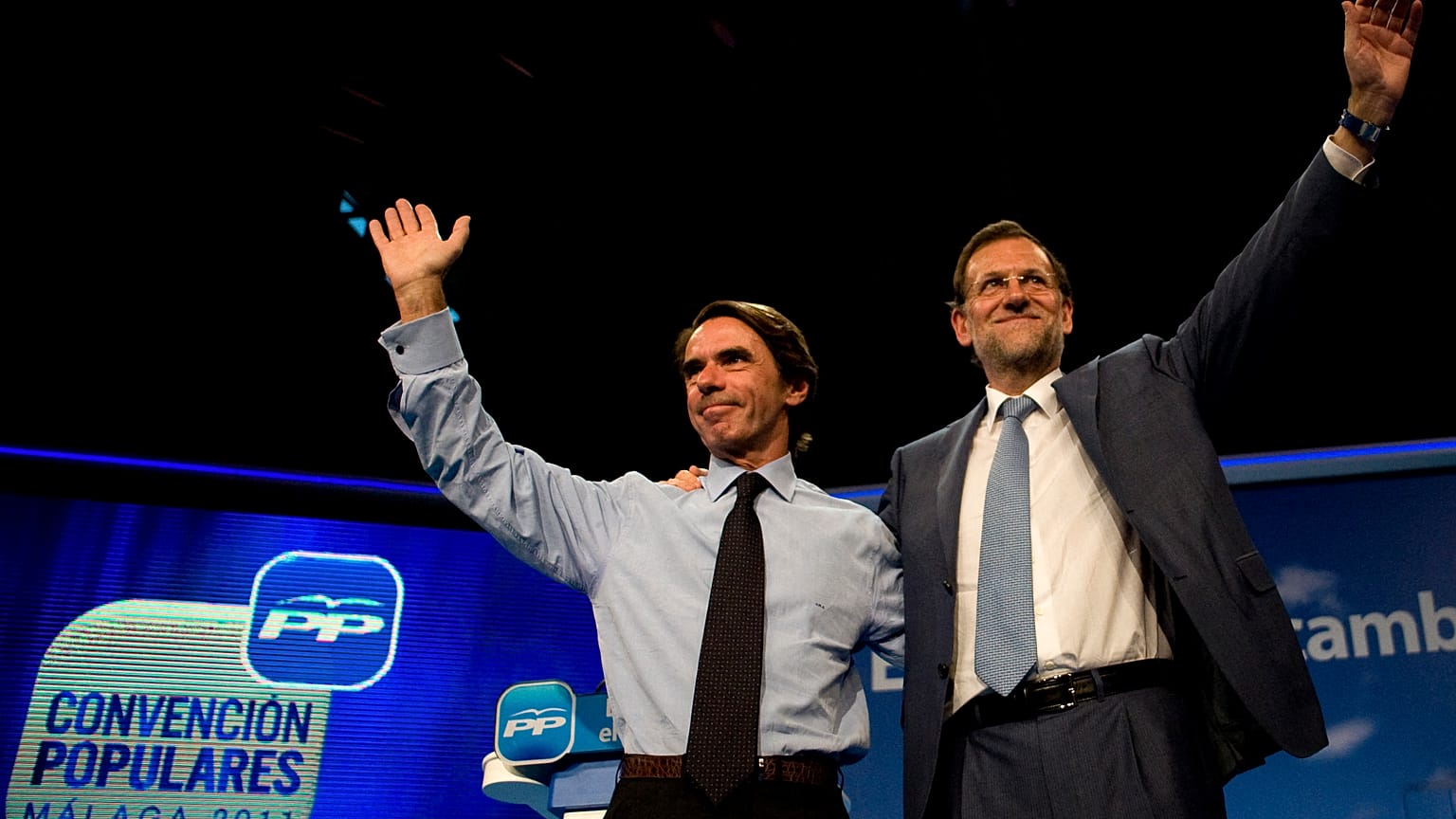 FILE:  Mariano Rajoy, then leader of the Spanish opposition party Partido Popular (PP), waves to supporters next to former PM Jose Maria Aznar, October 6, 2011