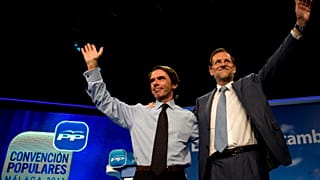 FILE:  Mariano Rajoy, then leader of the Spanish opposition party Partido Popular (PP), waves to supporters next to former PM Jose Maria Aznar, October 6, 2011