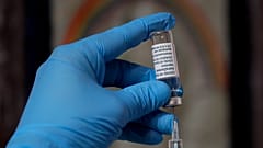 A syringe of the AstraZeneca vaccine is prepared in Ealing, London.