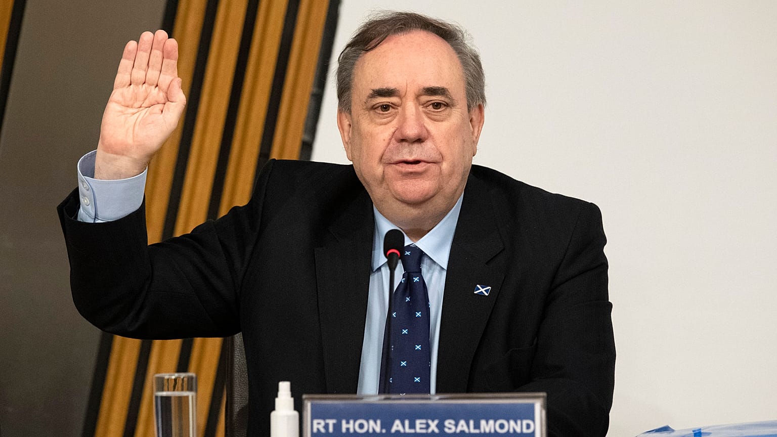 Former Scottish leader Alex Salmond is sworn in before giving evidence to a committee of the Scottish parliament at Holyrood in Edinburgh, Friday Feb. 26, 2021.