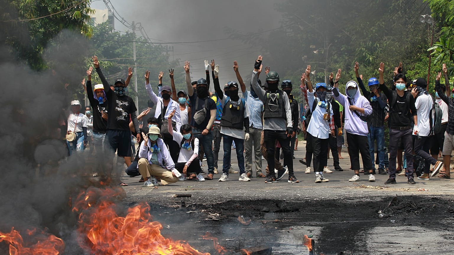 Anti-coup protesters gesture with a three-fingers salute, a symbol of resistance during a demonstration during by police crack down, Yangon, Myanmar, March 27, 2021.