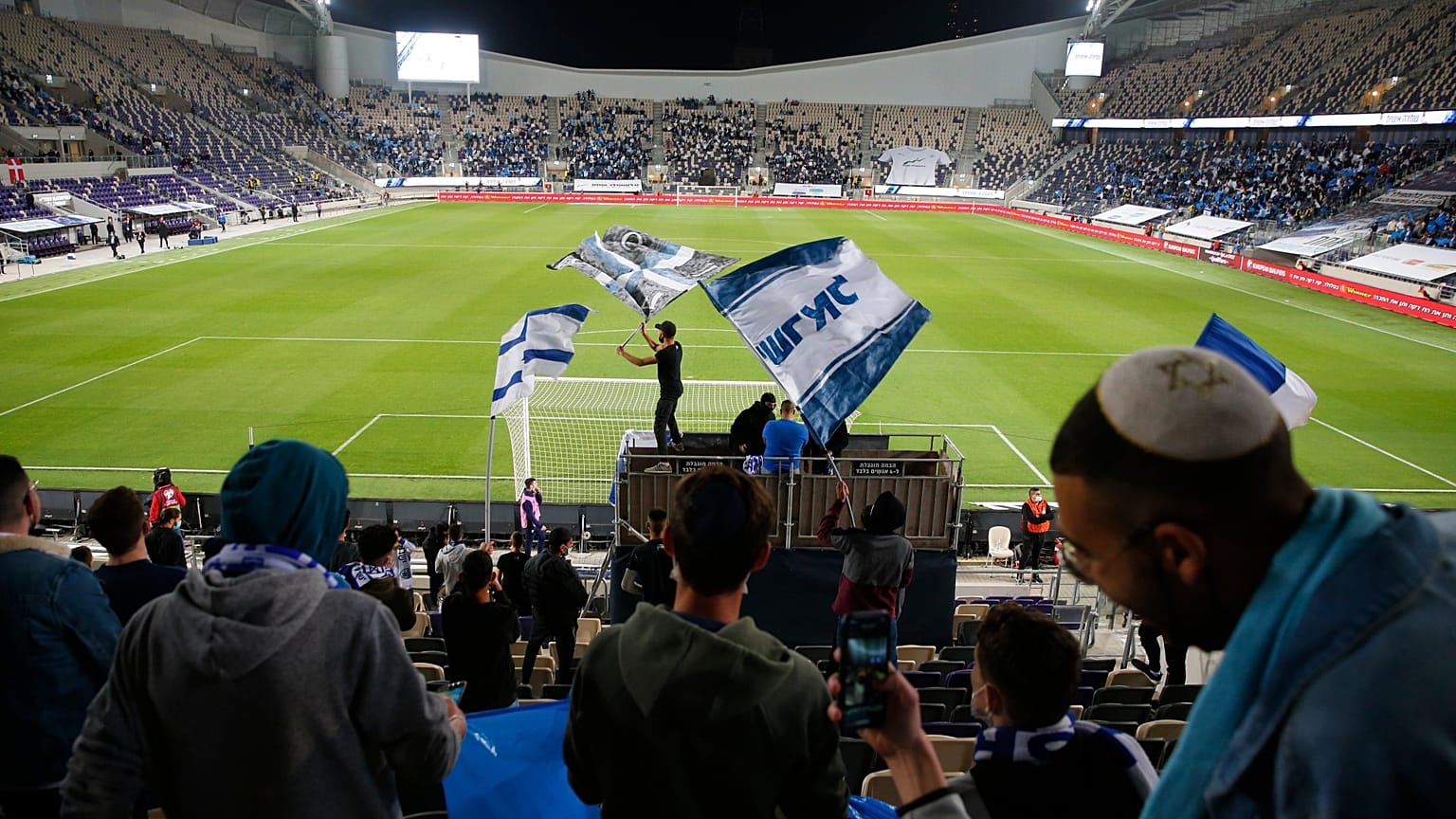 Israeli fans cheer before the World Cup 2022 group F qualifying soccer match between Israel and Denmark in Tel Aviv
