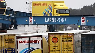 vehicles disembark from a ferry arriving from Scotland at the port of Larne, Northern Ireland Feb. 2, 2021.