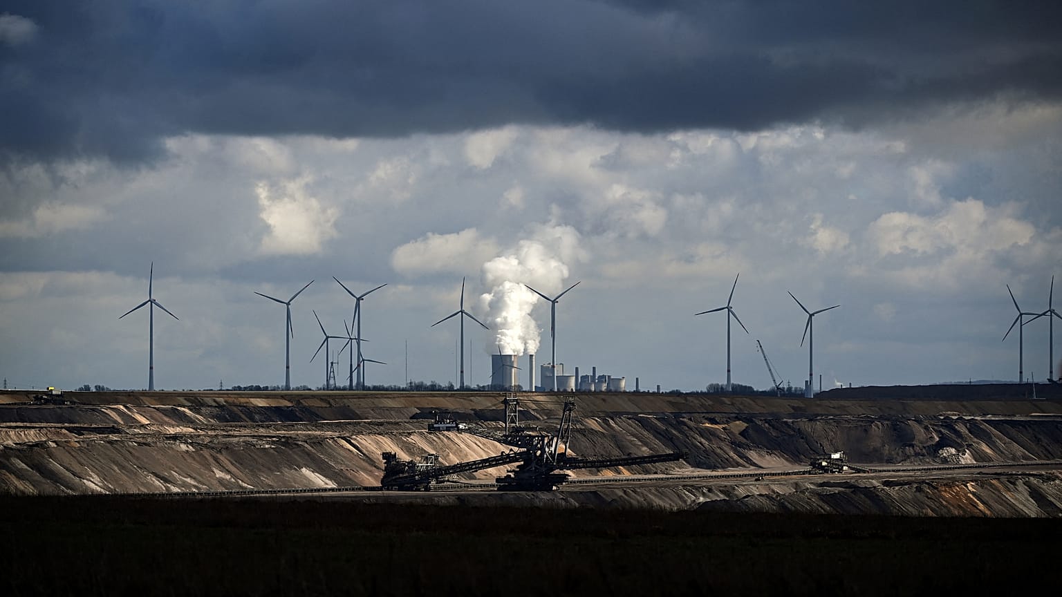 Wind turbines are seen near the open-cast mining and the coal-fired power station Neurath of German energy giant RWE in Garzweiler, western Germany.